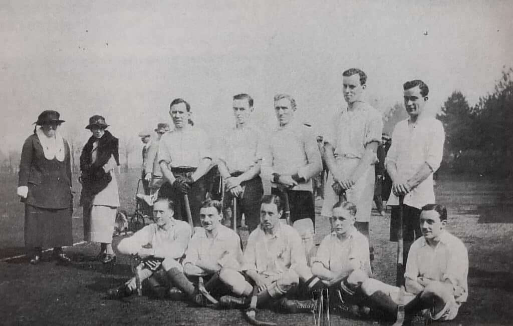 A black and white photo of a hockey team, Havant Travellers, at the Paris Hockey Festival.