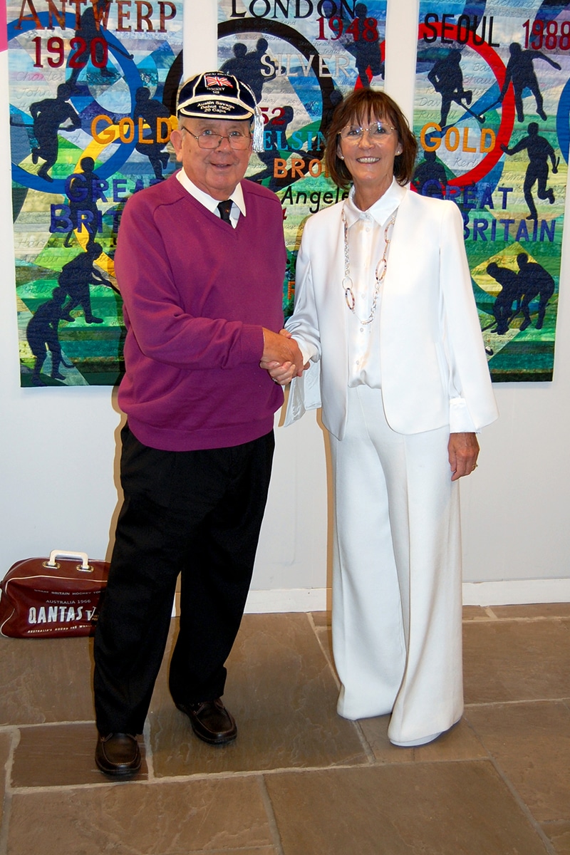 A colour image of Austin Savage receiving his GB honours cap at The Hockey Museum from Amanda Prosser in October 2021. 