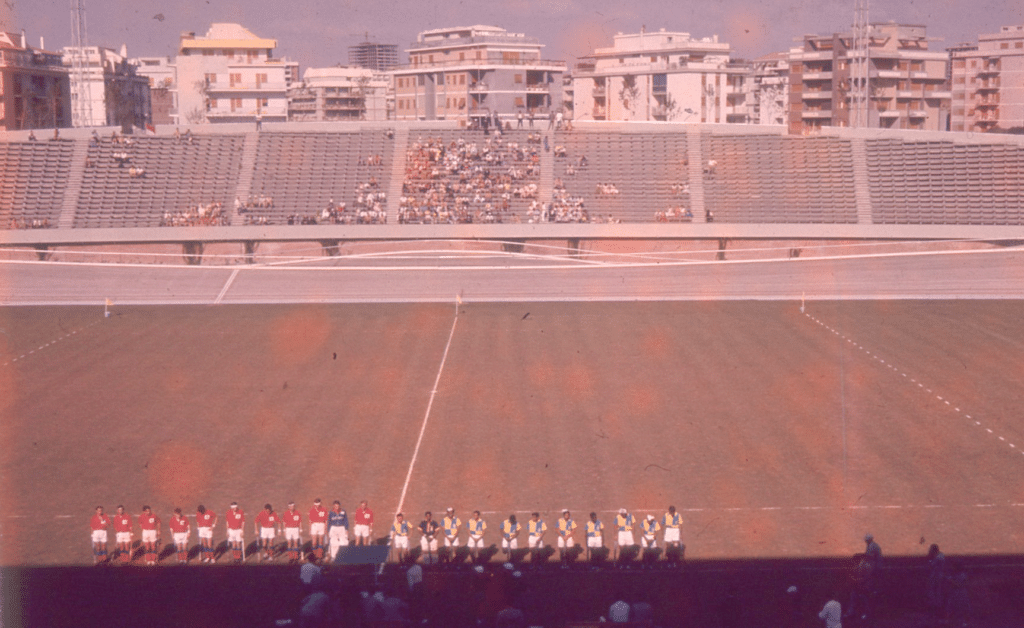 An image of Great Britain and India men's hockey teams lining up at the Velodromo Olimpico for the semi-final of the Rome 1960 Olympic hockey tournament. 