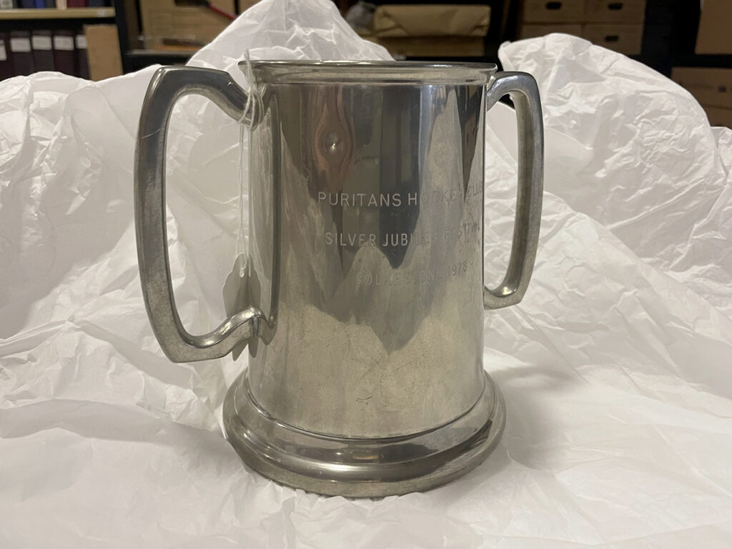 A colour image of an engraved silver tankard