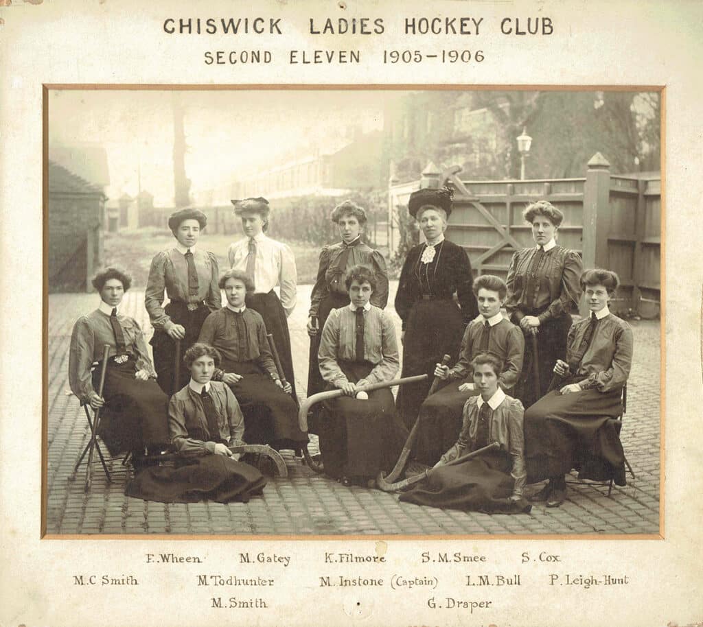 A black and white photo of a ladies hockey team