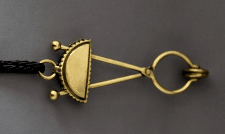 A small gold contraption "a skirt lifter"