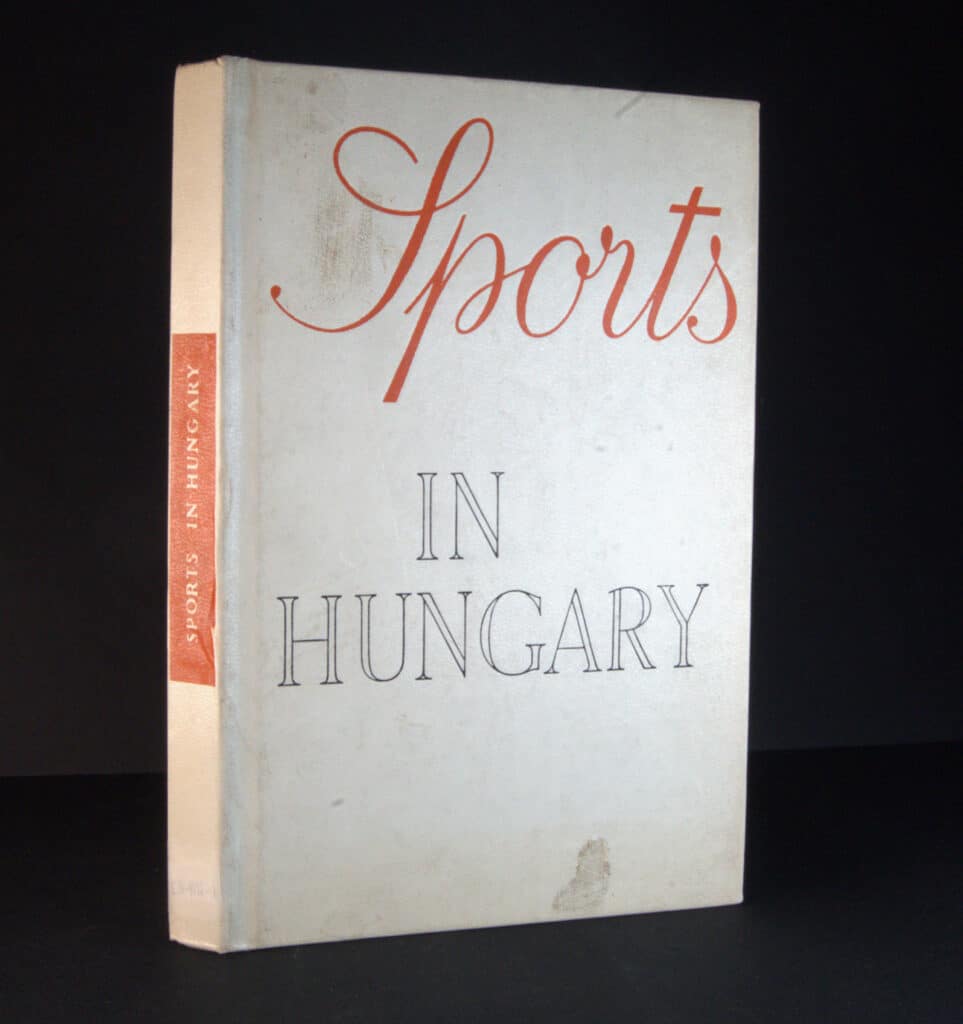 A picture of a white book a black background. The title on the front is in red font: "Sports in Hungary". The title on the spine is white font on a red rectangle. 