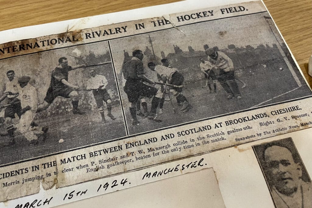 A newspaper clipping showing two black and white action photographs of an England versus Scotland men's hockey match.