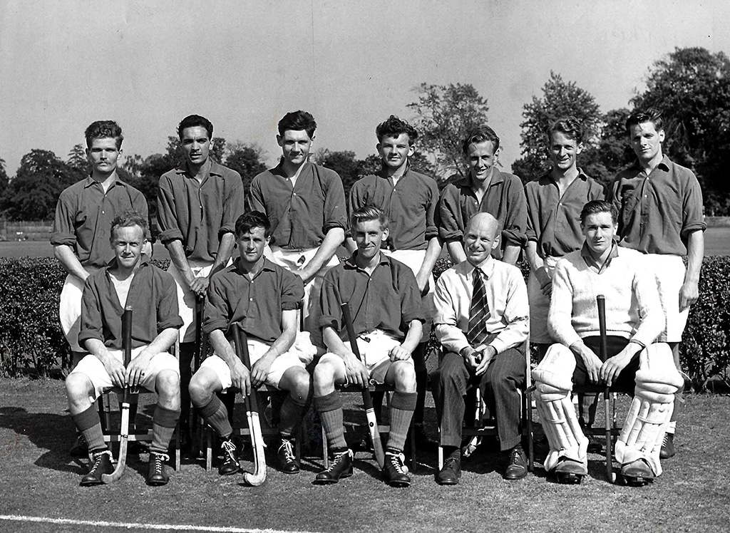 A mens hockey team posing for a team photo in black and white