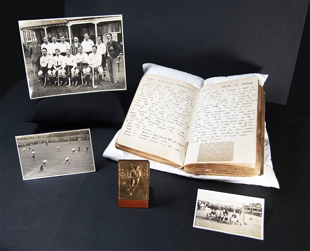 A colour photo of hocke memorabilia (photographs, scrapbook and medallion) laid out on a table