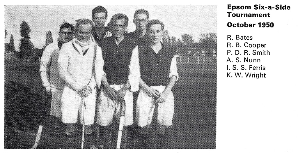 Six men in hockey attire posing for the camera for a black and white photo