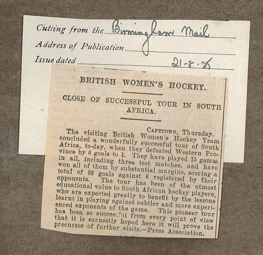 Photograph of a yellowing newspaper cutting stuck into a page of a scrapbook.
