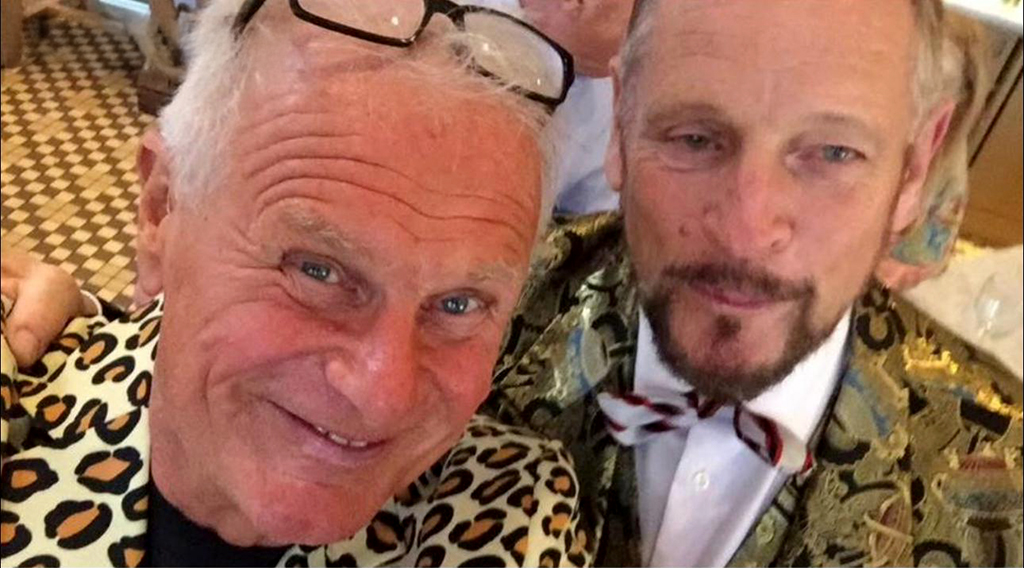 Two middle-aged men wearing bright suit jackets.