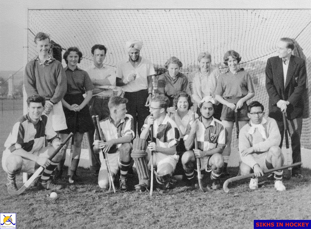 Black and white photograph of young male and female hockey players of various ethnicities standing in front of a goal.