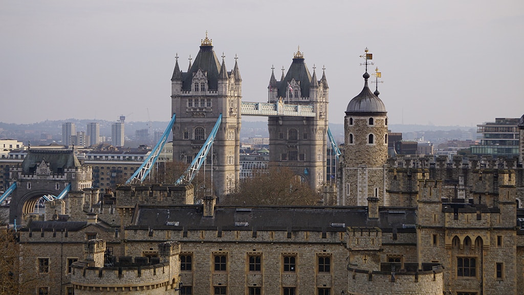 View of a castle and a large ornate bridge.