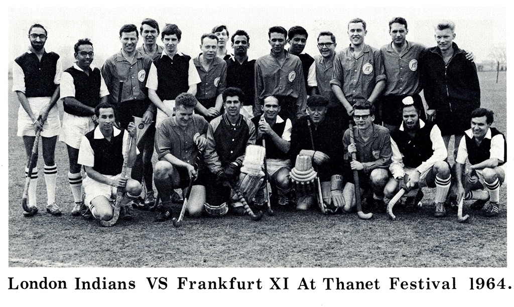 A large group of 22 young male hockey players of various ethnicities pose for a photograph in two rows, the back row standing and the front row crouching.