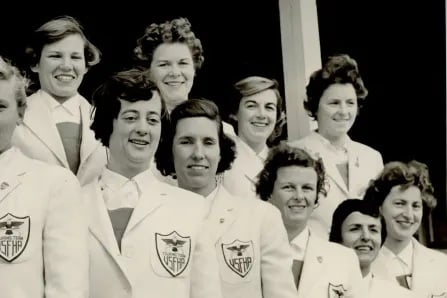 A group of young women wearing white blazers.