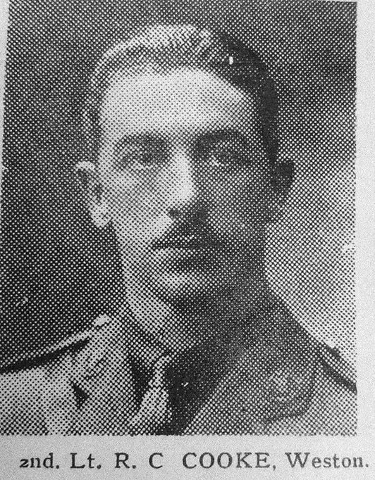 Headshot photograph of a young man with short hair and a thin moustache in military uniform