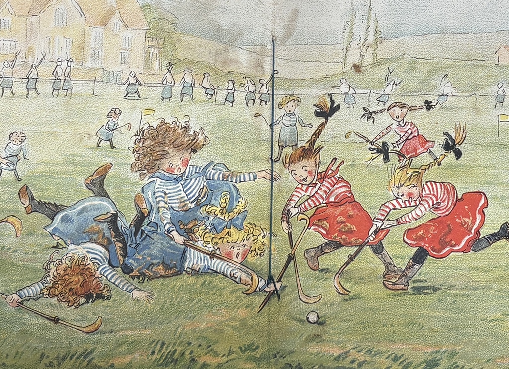 Illustration of a children's hockey match, with players in red and blue striped tops competing for the ball while several others tumble to the ground. Spectators line the edge of the hockey pitch in the background.