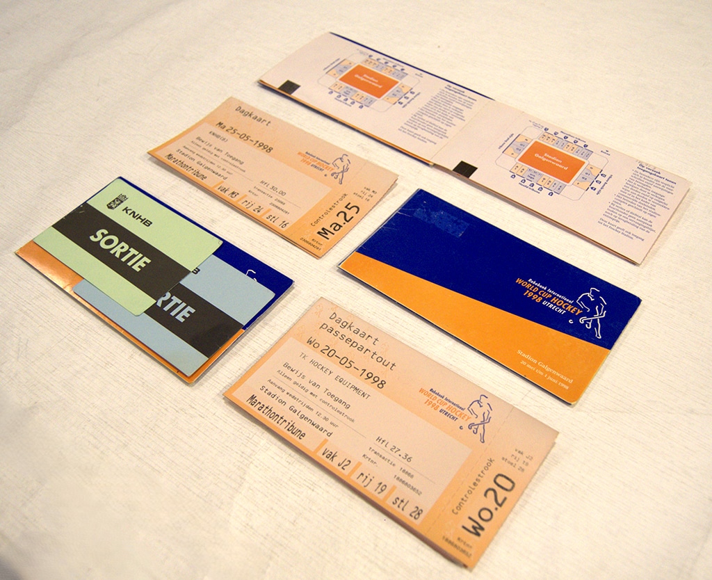 Selection of tickets and passes displayed in a two-by-three grid on a light cream surface.