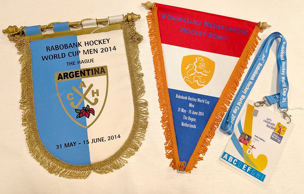 Two pennants and an accreditation pass on a lanyard. The pennants
