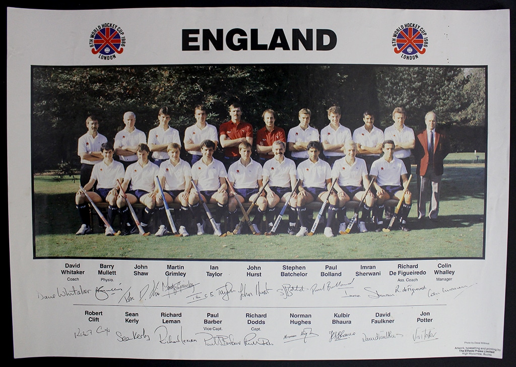 Poster of a men's hockey team positioned in two rows, wearing white polo shirts, navy blue shorts and socks. The players' signatures are along the bottom under the central photograph.